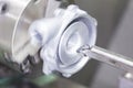 Operator turning automotive parts by cnc lathe