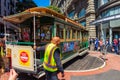 Operator turning a cable car around in the reverse direction at the Powell and Market Street Turntable in San Francisco USA