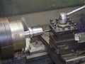 Operator turning mold parts by manual lathe