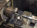 Operator turning mold parts by manual lathe