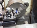 Operator turning mold parts by manual lathe