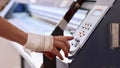 Operator turns on printing process of inkjet printing press with ciss system. Royalty Free Stock Photo
