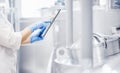 Operator uses tablet computer to check quality and temperature of yeast fermentation in tanker hops and malt, beer