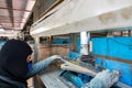 Operator or worker use steel plate for inspection product after press down by manual hydraulic bending machine at factory Royalty Free Stock Photo