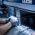 Operator working cut and bending metal sheet Royalty Free Stock Photo