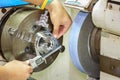 Opertor measuring cnc grinding part