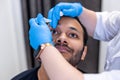 Ophtalmologist dropping eye drops to patients eyes