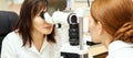 Ophthalmologist doctor in exam optician laboratory with female patient. Eye care medical diagnostic. Eyelid treatment Royalty Free Stock Photo