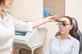 Ophthalmologist doctor in exam optician laboratory with female patient. Eye care Royalty Free Stock Photo