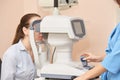 Ophthalmologist doctor in exam optician laboratory with female patient. Eye care Royalty Free Stock Photo