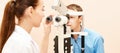 Ophthalmologist doctor in exam optician laboratory with male patient. Men eye care medical diagnostic. Eyelid treatment Royalty Free Stock Photo