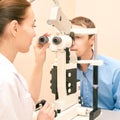 Ophthalmologist doctor in exam optician laboratory with male patient. Men eye care medical diagnostic. Eyelid treatment Royalty Free Stock Photo