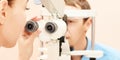 Ophthalmologist doctor in exam optician laboratory with male patient. Men eye care medical diagnostic. Eyelid treatment Royalty Free Stock Photo