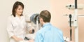 Ophthalmologist doctor in exam optician laboratory with male patient. Men eye care medical diagnostic. Eyelid treatment Royalty Free Stock Photo