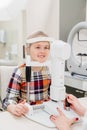 ophthalmologist examines the girl on a corneo topographer. modern clinic.