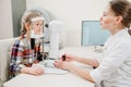 ophthalmologist examines the girl on a corneo topographer. modern clinic.