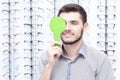 Ophthalmologist examines the young man in the clinic. Consultation of an ophthalmologist. Medical equipment.