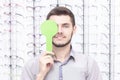 Ophthalmologist examines the young man in the clinic. Consultation of an ophthalmologist.