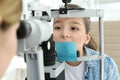 Ophthalmologist examining little girl