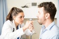 Ophthalmologist examining sore throat of a patient Royalty Free Stock Photo