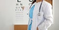 Ophthalmologist standing on background of table measuring vision closeup