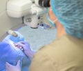 Ophthalmologist surgeon at the modern laser eye surgery apparatus. Close up doctor treats cataract to patient in operating room