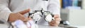 Ophthalmologist with trial frame for selection of complex astigmatic glasses Royalty Free Stock Photo