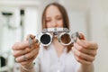 ophthalmologist with trial frame for selection of glasses. selective focus Royalty Free Stock Photo