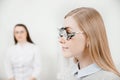 Ophthalmologist woman doctor checks diagnose eyesight myopia, hyperopia young woman. Royalty Free Stock Photo