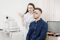 Ophthalmologist woman doctor checks diagnose eyesight myopia, hyperopia young man. Royalty Free Stock Photo