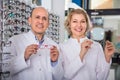 Ophthalmologists standing near display with spectacles