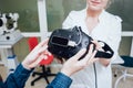 Ophthalmology doctor checks the girl`s vision with virtual reality goggles.