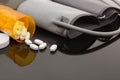 Opiod pills spilled out on table with reflective surface Royalty Free Stock Photo