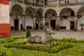 Opocno castle, renaissance chateau, courtyard with arcades and red facade, palm trees and plants in ceramic pots, deer statue,