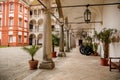 Opocno castle, renaissance chateau, courtyard with arcades and red facade, palm trees and plants in ceramic pots, old cannons, Royalty Free Stock Photo