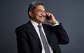 When opportunity calls, answer. Studio shot of a mature businessman talking on his cellphone. Royalty Free Stock Photo