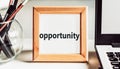 OPPORTUNITY text in wooden frame on office table