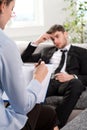 Oppressed man talking with psychologist Royalty Free Stock Photo