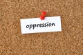 Oppression. Word written on a piece of paper, cork board background