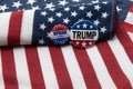 Oprah 2020 presidential badge and Trump 2020 badge against United States flag