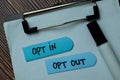 Opt In or Opt Out text on sticky notes with office desk