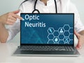 Optic Neuritis text in list. Immunologist looking for something at laptop