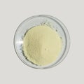 Optical brightener powder in chemical watch glass on white laboratory table. Top View Royalty Free Stock Photo