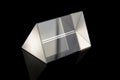 Optical prism for experiments isolated on the black background Royalty Free Stock Photo