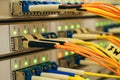 The optical wires are connected to the central router. The network cables are connected to the main server. The front panel of the Royalty Free Stock Photo