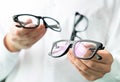 Optician comparing lenses or showing customer different options Royalty Free Stock Photo