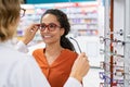 Optician comparing spectacles with client Royalty Free Stock Photo