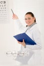 Optician doctor woman with glasses and eye chart