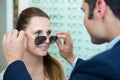 optician fitting prescription sunglasses on client Royalty Free Stock Photo