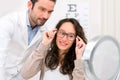 Optician helping out a woman to choose glasses